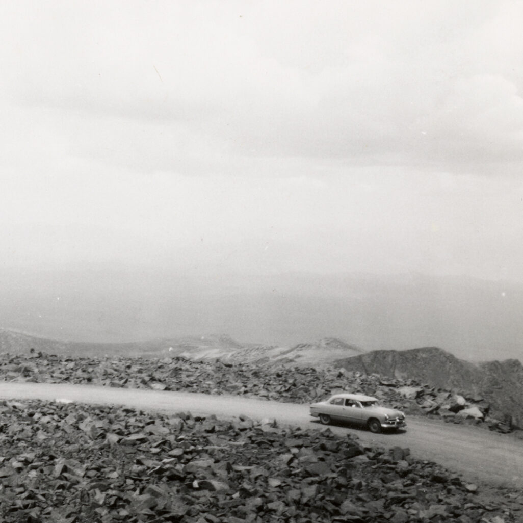 Car driving on an open road.