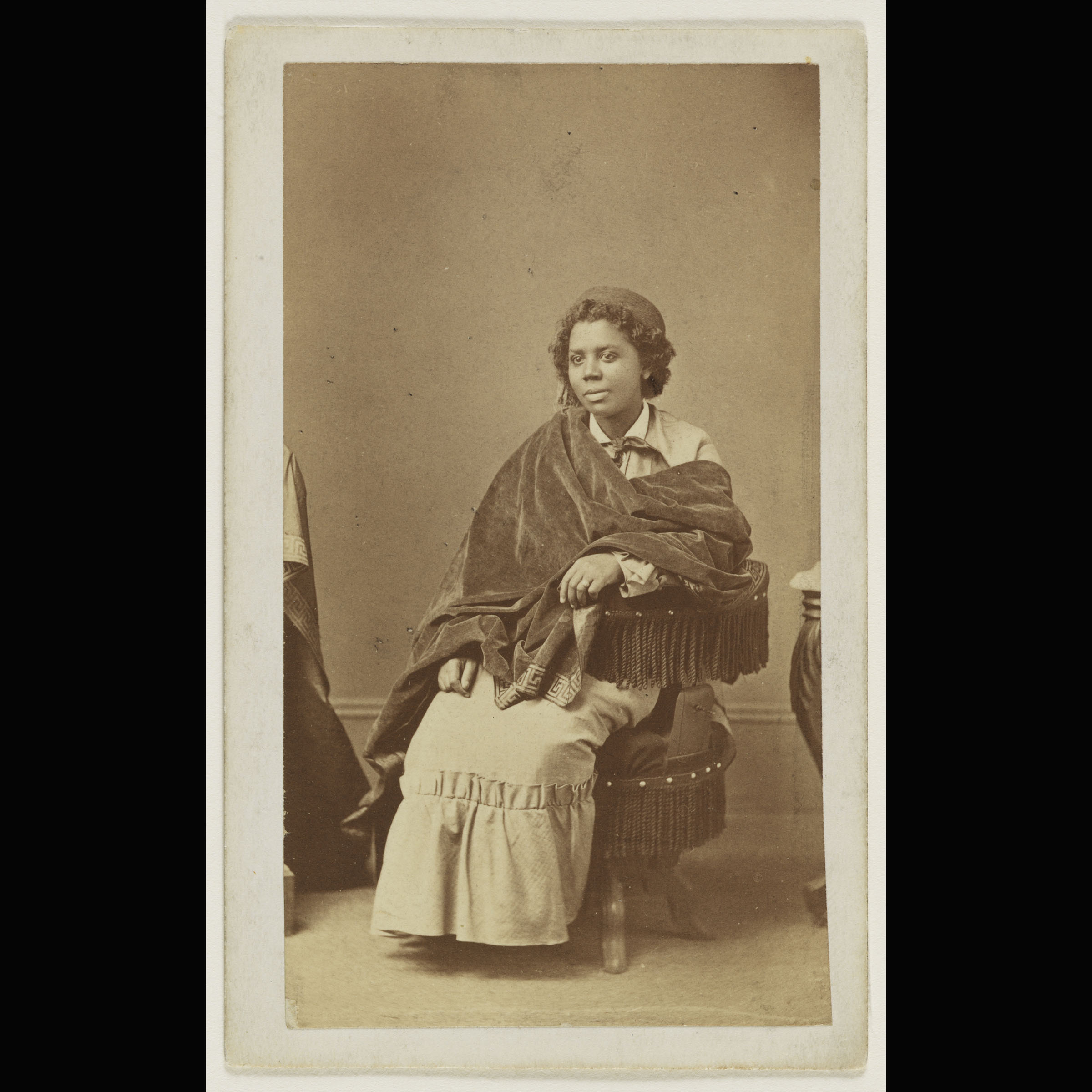 Archival photograph of Black woman seated, facing the camera.