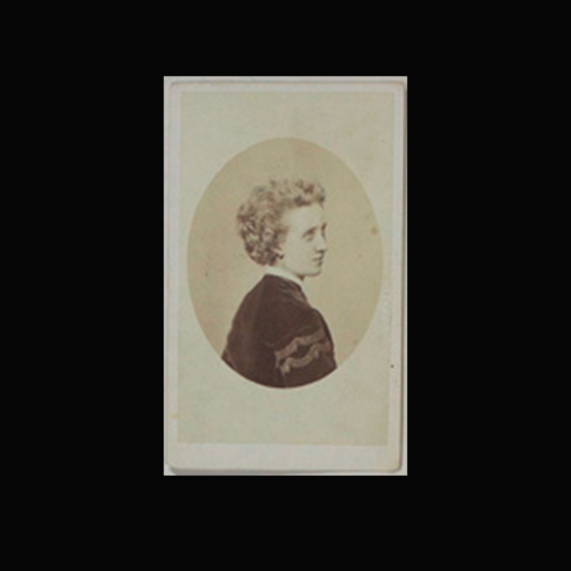 A 19th-century photograph of a woman, showing her face in profile, with her back turned to towards the camera.