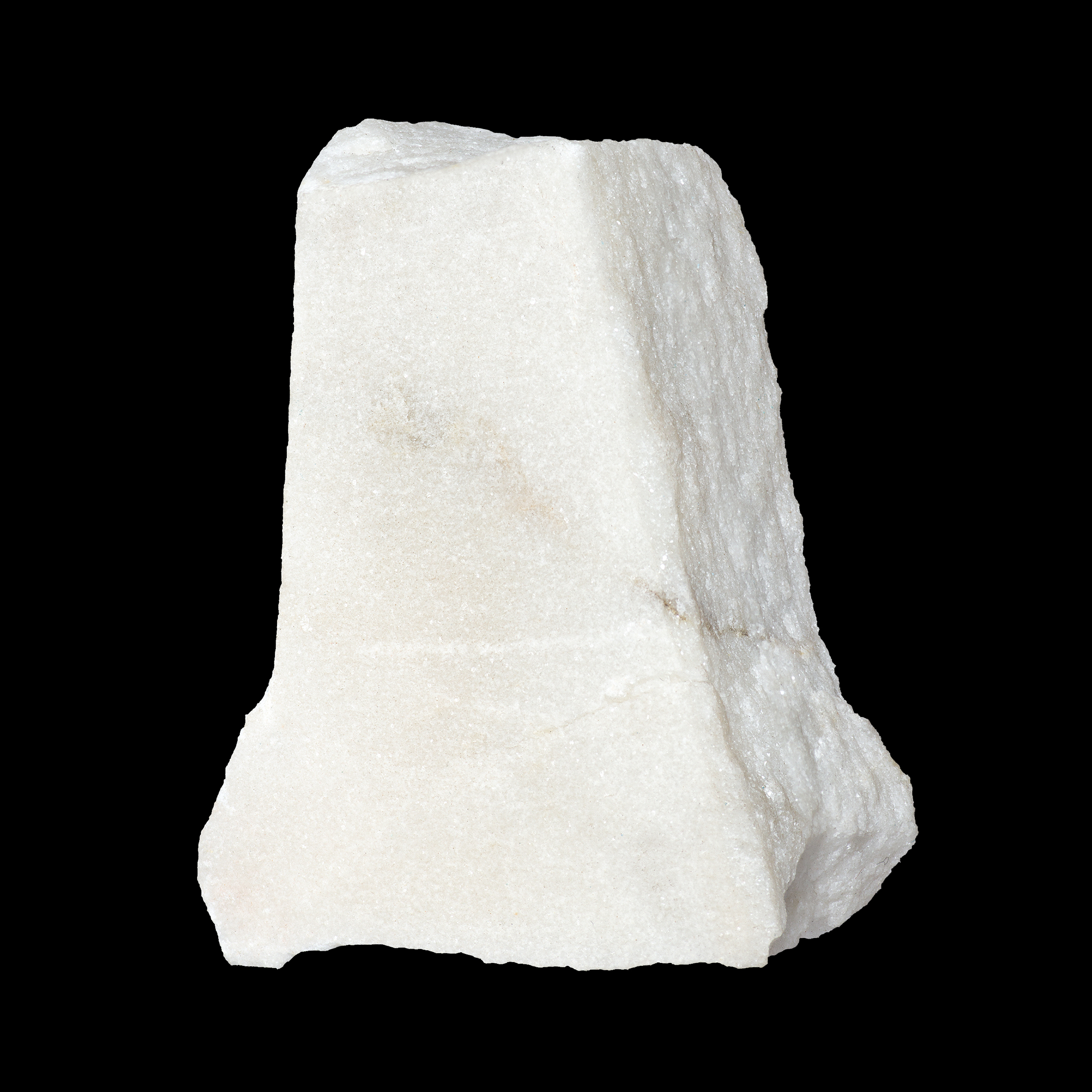 Marble block in a rough rectangular shape, on a black background.