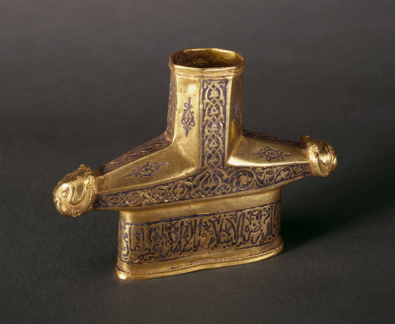 Sword Hilt with Design of Lion Heads, Arabesque Scrollwork, and Arabic Inscription