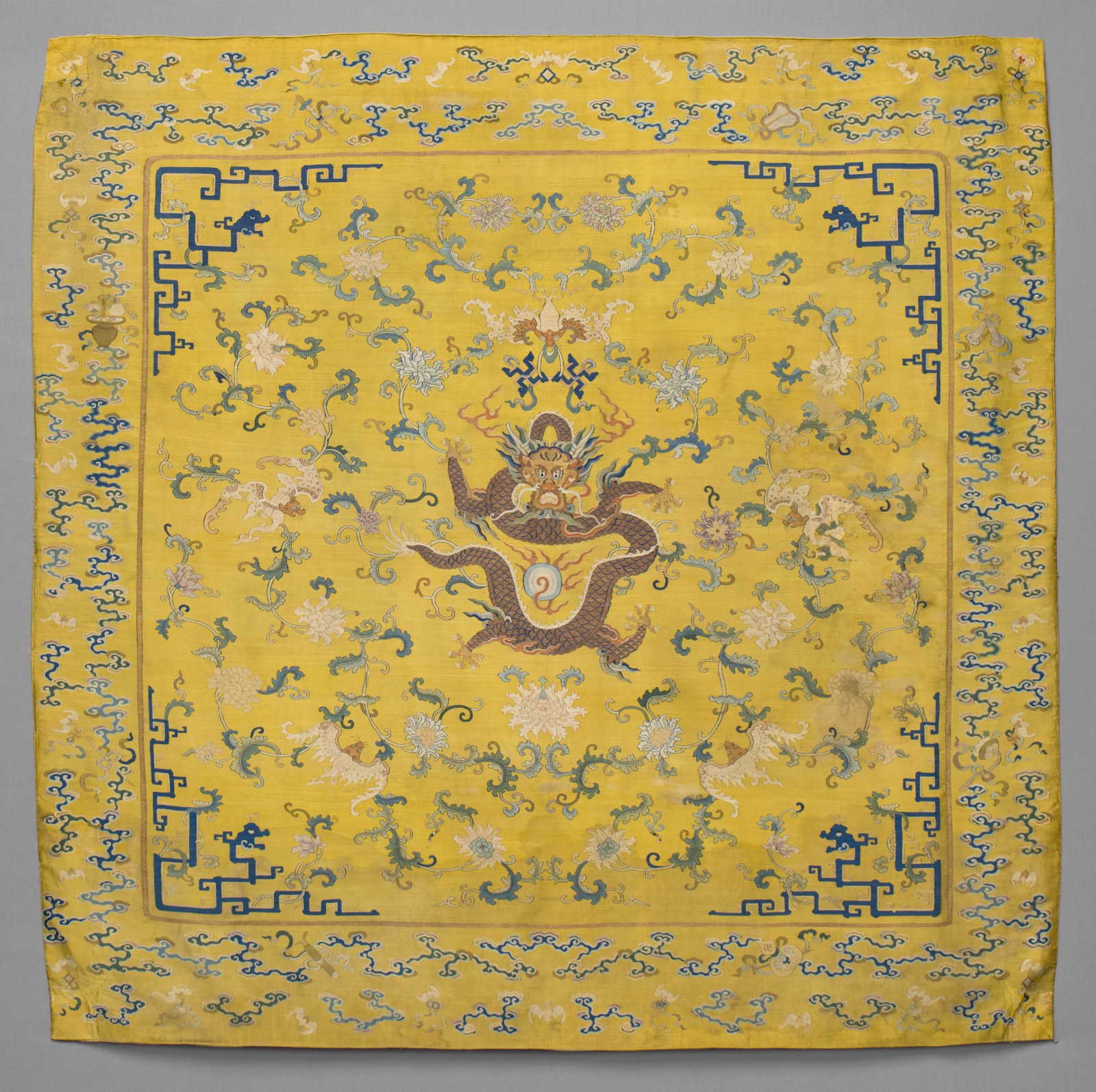 Imperial Chair Cover with Design of Five-Clawed Dragons and Bats amidst Peony Scrolls and Border with the Eight Daoist Emblems and Multicolored Clouds